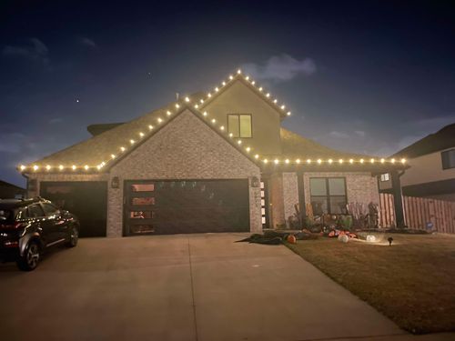 A car parked in front of a house covered in christmas lights