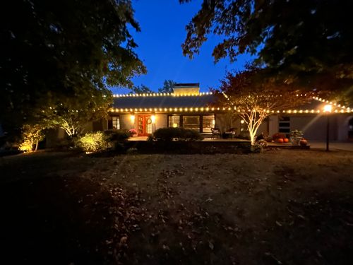 A house is lit up with christmas lights